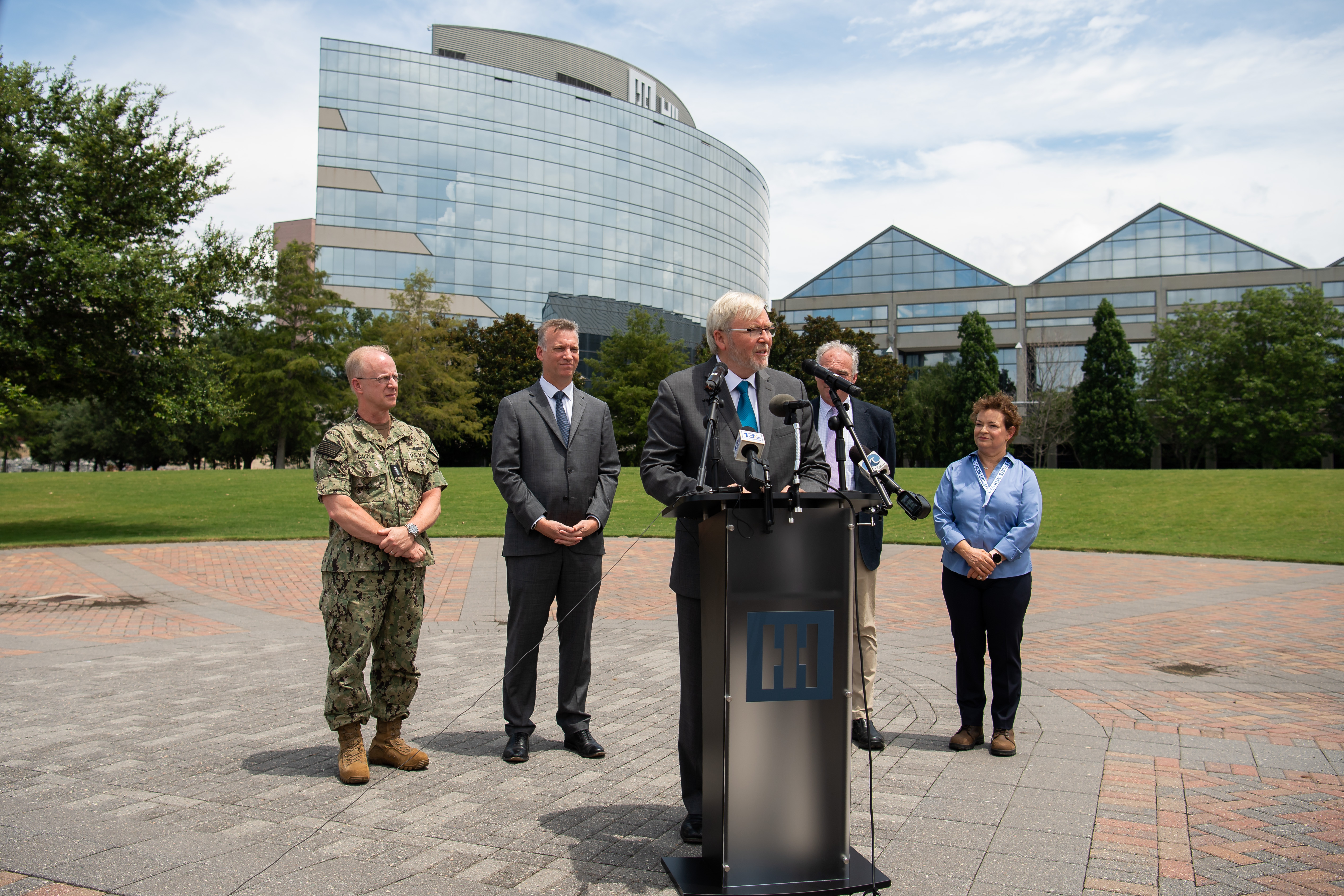 Dr. Kevin Rudd, Australian Ambassador to the United States of America, speaks during a news conference about the AUKUS agreement outside HII on Friday, July 14, 2023. Behind him are, from left, Adm. Daryl Caudle, commander, U.S. Fleet Forces Command; Under Secretary of the Navy Erik Raven; U.S. Sen. Tim Kaine (D-Va.); and NNS President Jennifer Boykin. (Photo by Lexi Whitehead/HII).