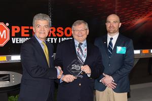 David Moniz, Publisher, HDT magazine presents a 2019 ‘Top 20 Products’ award to Peterson’s Al Anderson and Cory Adams.