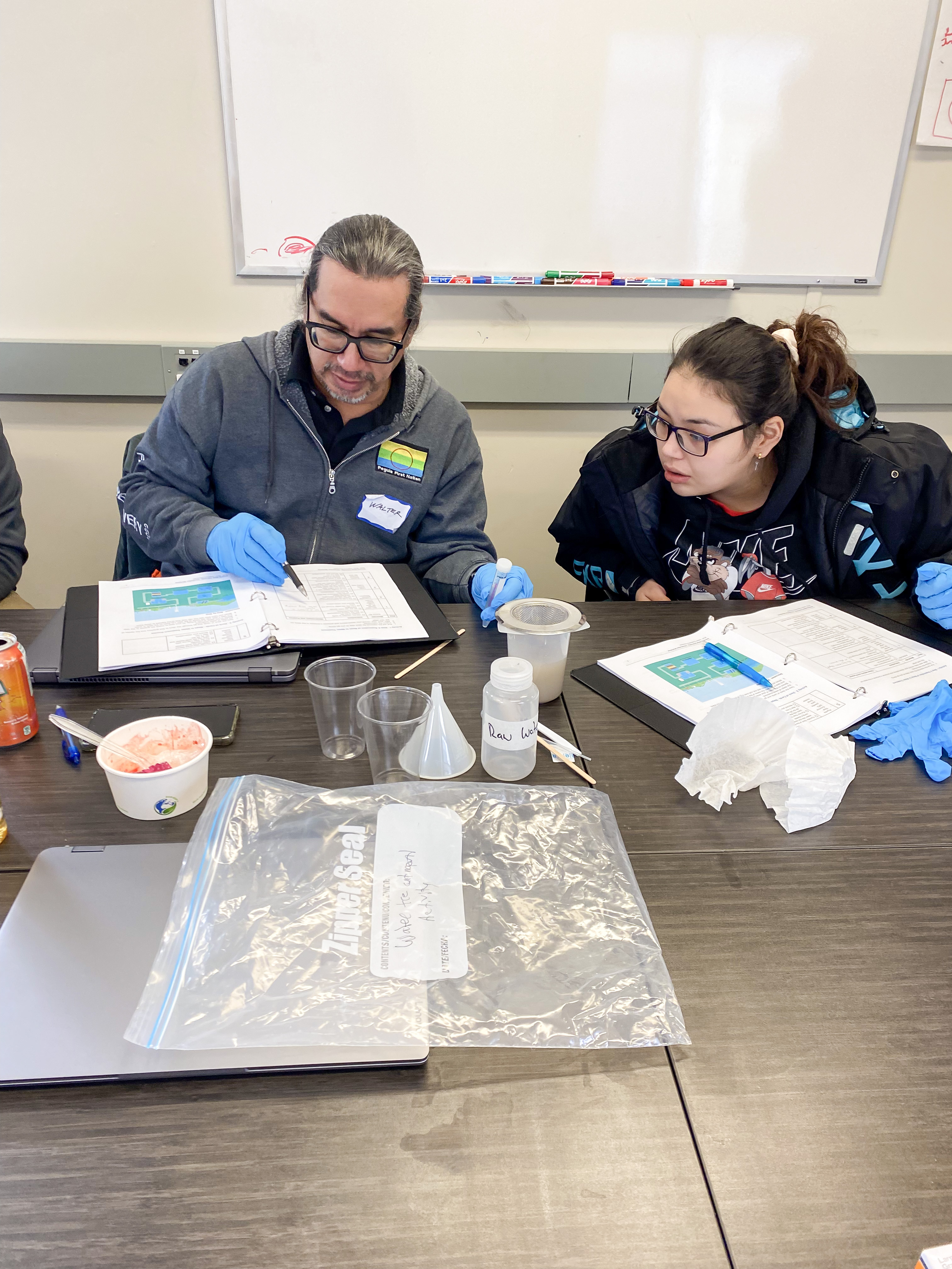 Walter Spence (left) and Jo-Dee Parenteau (right) learning about the water treatment process, IRTC week 1