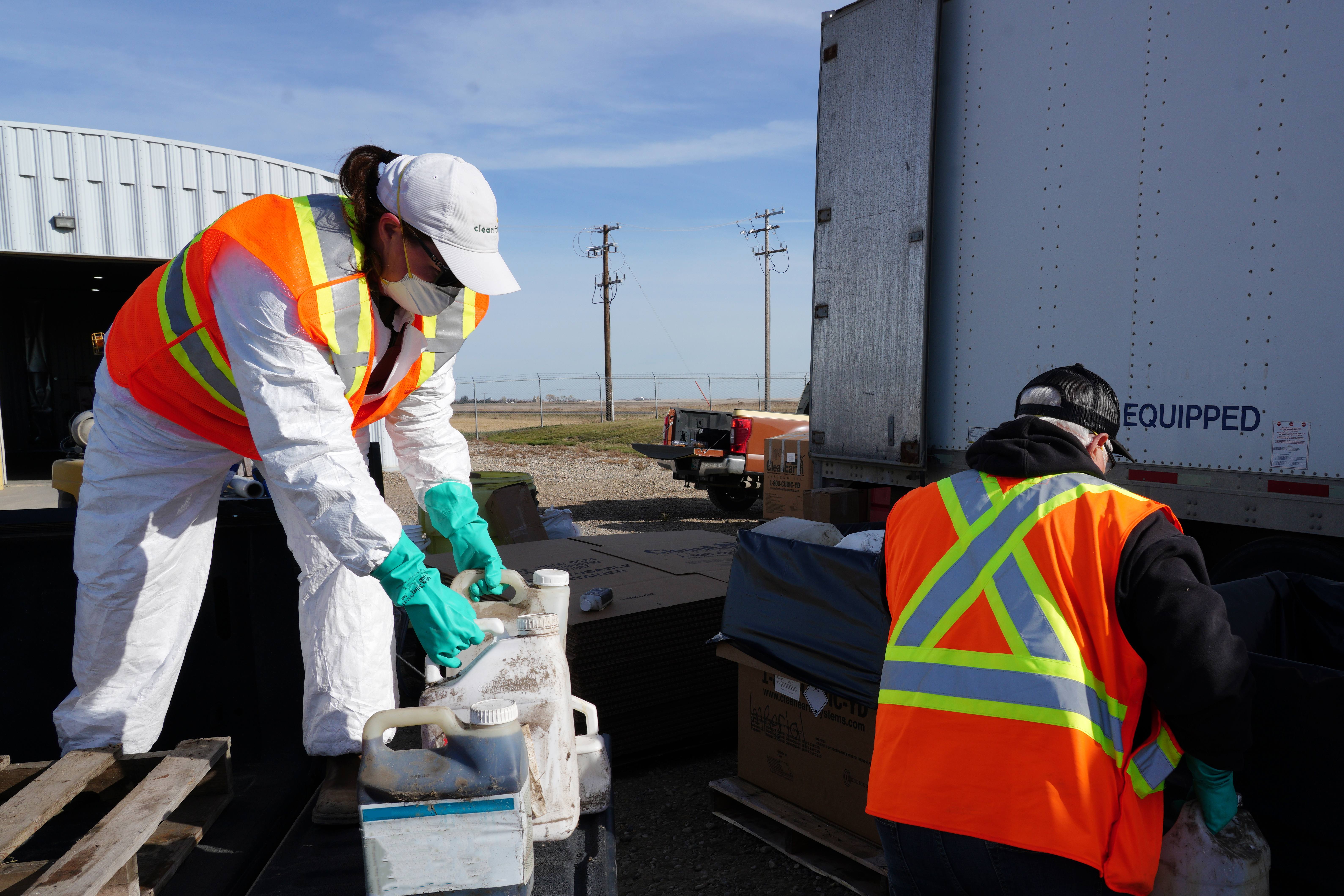 Unwanted pesticides and old livestock medications being dropped off and sorted at a collection site for safe disposal.