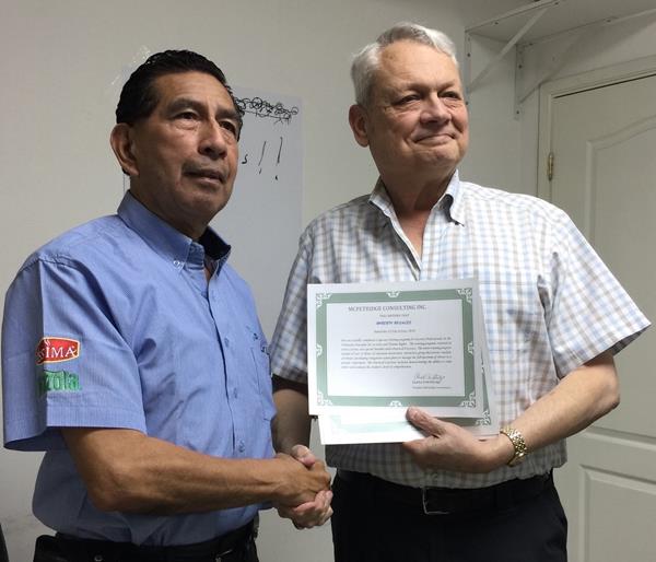 “Roberto Rosales (L), Dinant Security Manager for Guatemala, receives his training certificate from Don McFetridge, internationally-renowned security and human rights expert.”