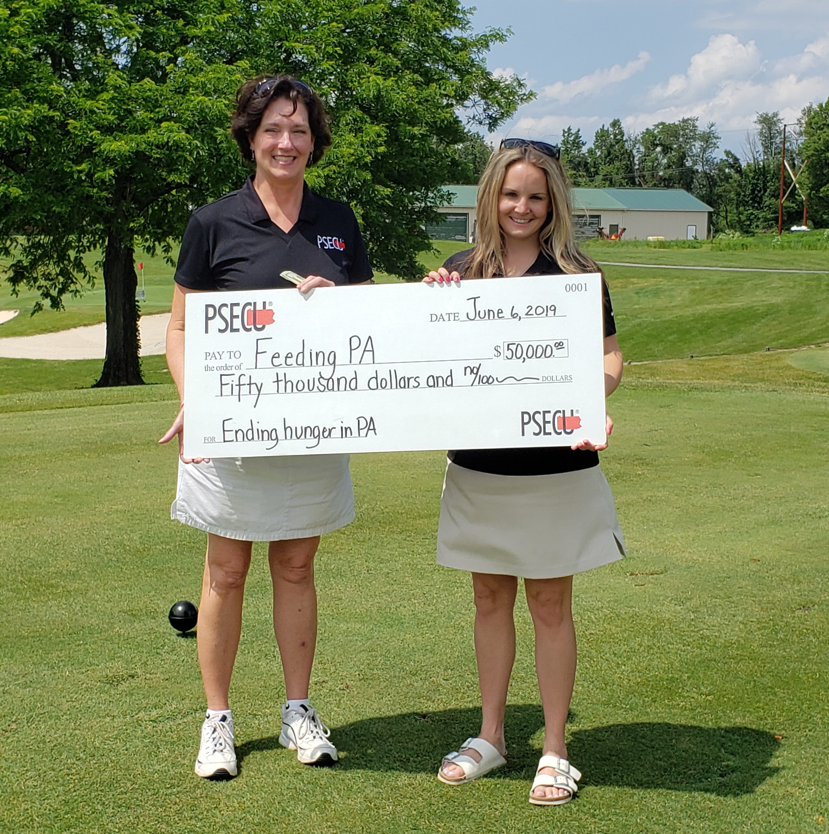 Barb Bowker, PSECU Vice President of Marketing and Membership Development (left), presents Jane Clements-Smith, Feeding Pennsylvania Executive Director (right), with a check for $50K at the 2019 PSECU Chips In Golf Outing on June 6.

