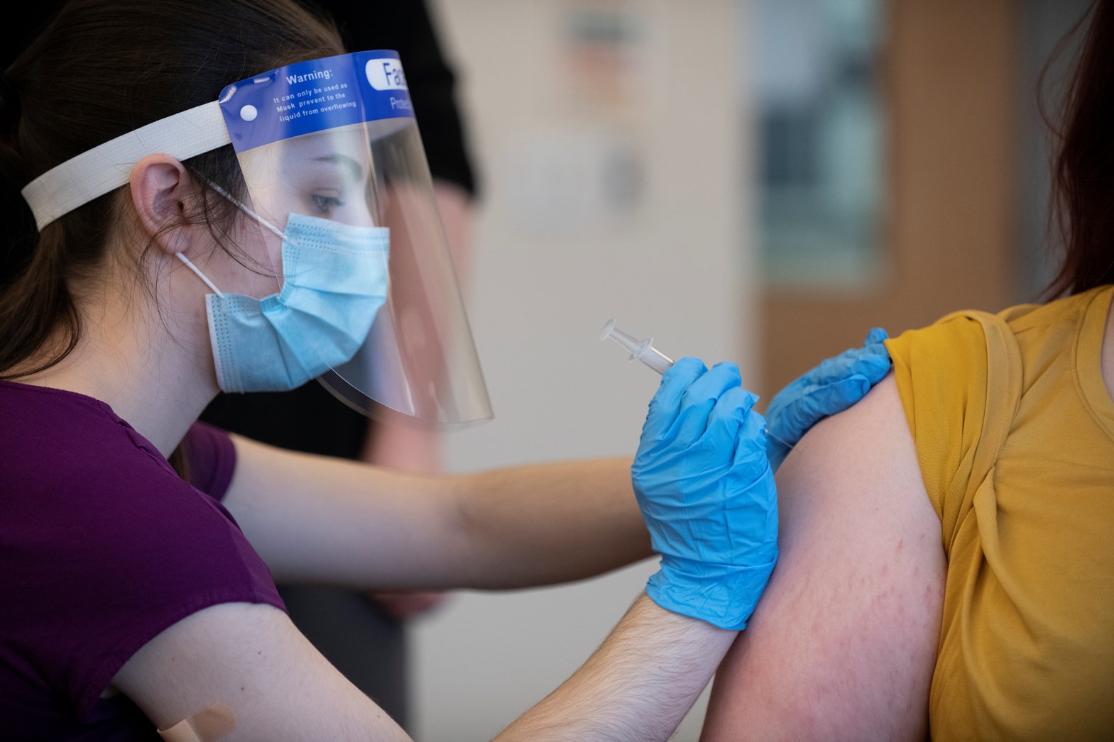 Husson University's School of Pharmacy trains licensed pharmacy technicians, pharmacy interns and practicing pharmacist in the ways to properly administer vaccines. In this photo, Lindsey Caron, a second-year pharmacist at Husson's School Pharmacy in Bangor, Maine practices giving an inoculation to a classmate.  