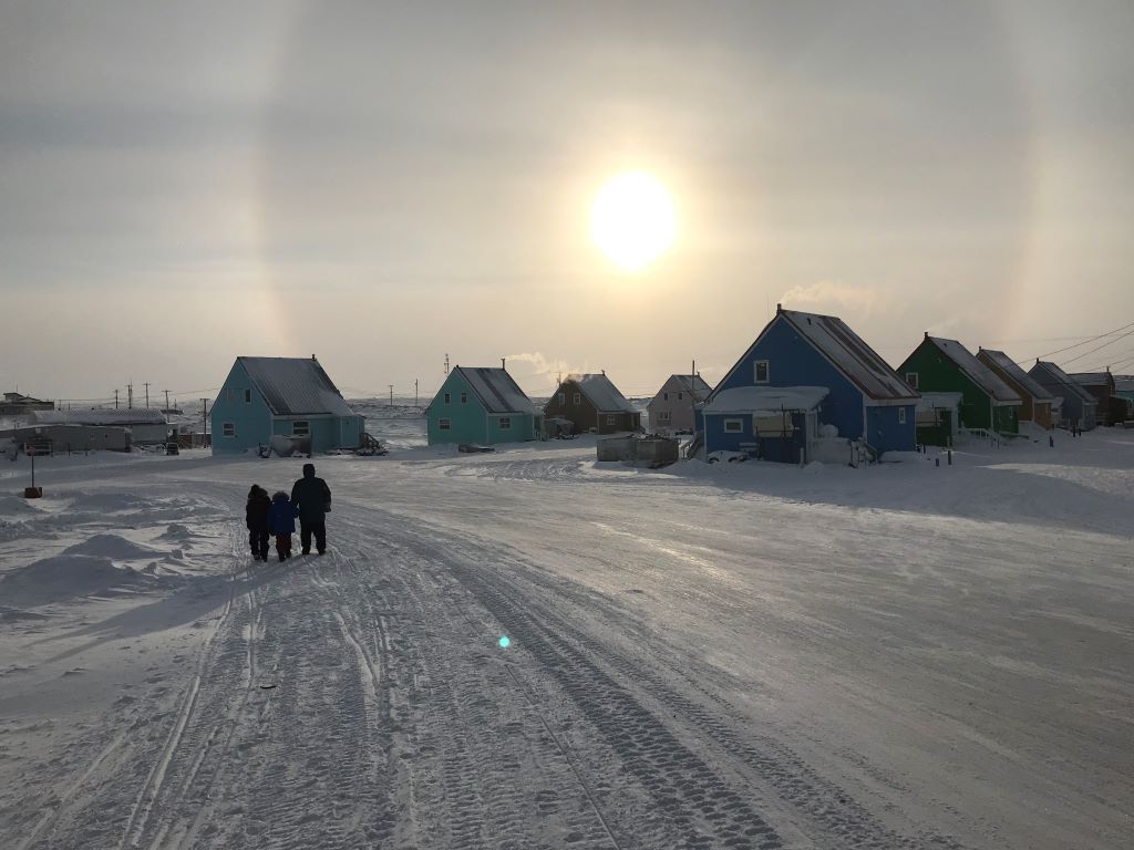 Community members walking under a sundog in Taloyoak, NU © Brandon Laforest / WWF-Canada