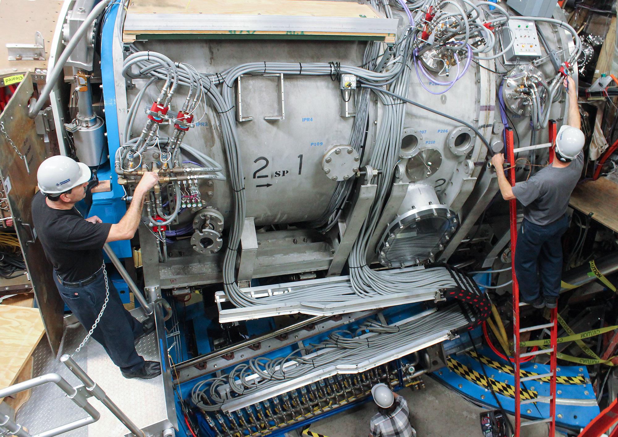 PHOTO CAPTION: DIII-D personnel complete final checks on a steerable neutral beam injector, one of several new state-of-the-art tools installed during a recently completed facility upgrade. Photo courtesy of General Atomics.