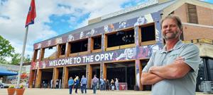 John Taylor, owner of Minuteman Press, Nashville, TN, proudly stands outside the newly rebranded Grand Ole Opry House.