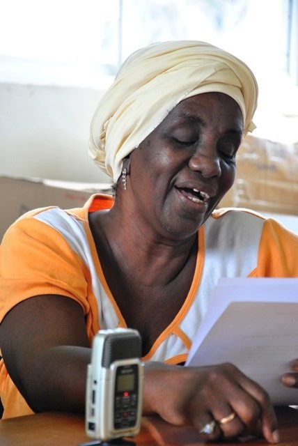 A Population Media Center actress reads from her script in studio. Photo by Population Media Center.