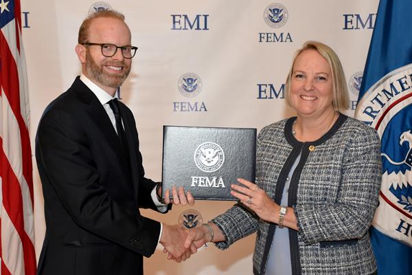 Emmitsburg, MD September 26, 2019—FEMA’s Emergency Management Institute (EMI) graduated Shanti Smith-Copeland, CEM, FPEM who completed all requirements of the National Emergency Management Executive Academy. Dr. Daniel Kaniewski, serving dual roles as Acting Deputy Administrator, and the Deputy Administrator for Resilience, Federal Emergency Management Agency, U.S. Department of Homeland Security is shown congratulating Shanti Smith-Copeland, CEM, FPEM as she graduates. Photo by Shane Gibbon / FEMA