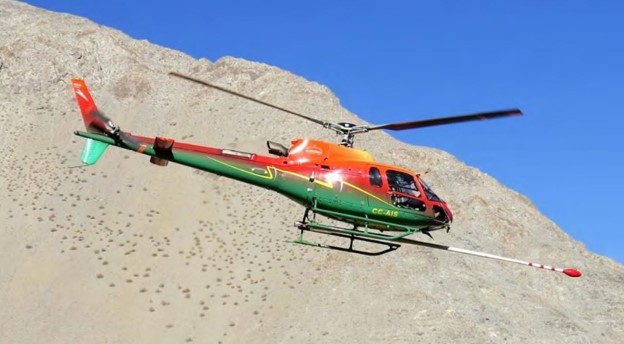 Image 1: Airbus AS350 B3 (ASTAR) helicopter pictured flying the magnetic-radiometric survey at Salvadora