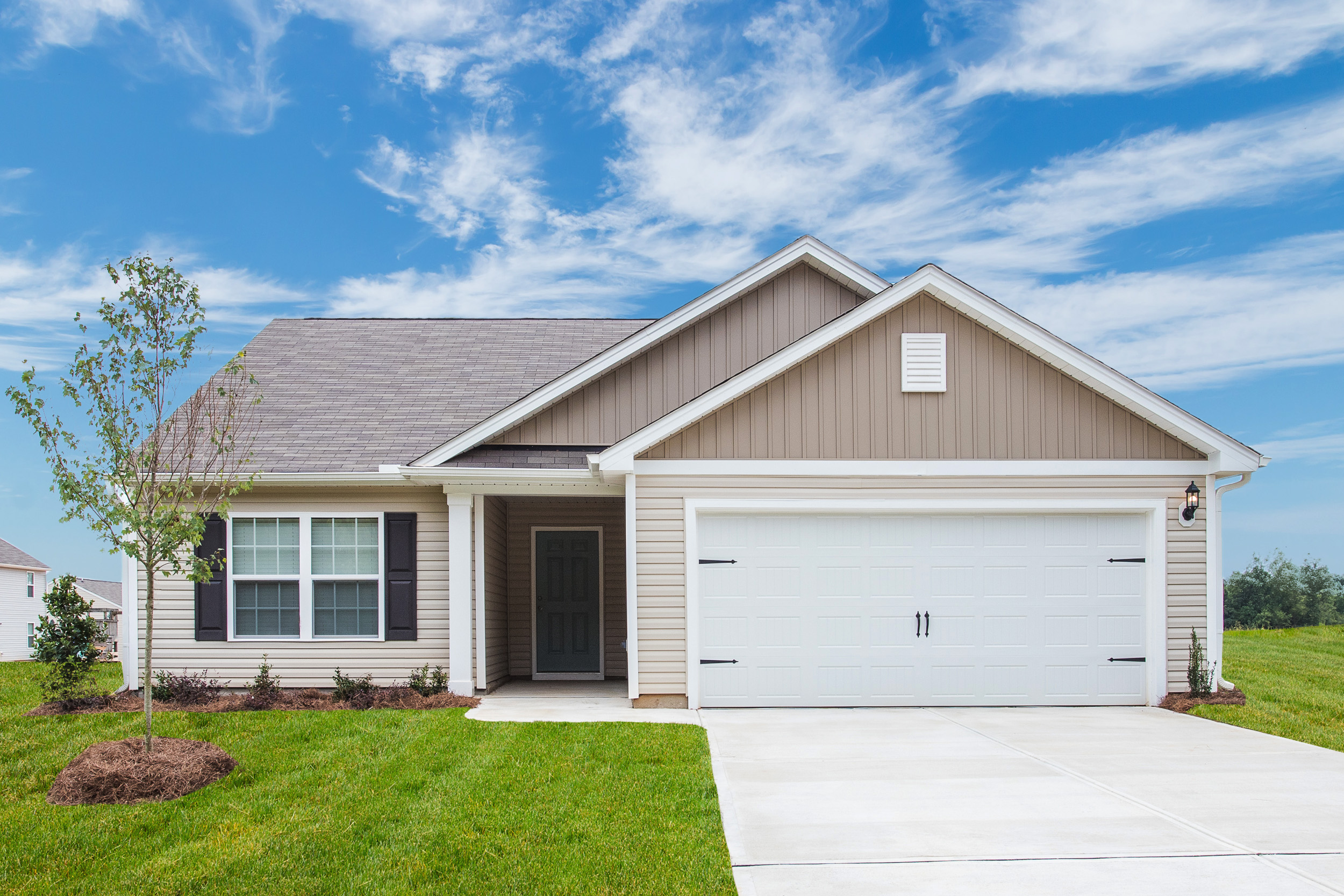 The Alamance floor plan includes a spacious living room and a chef-ready kitchen with stainless steel appliances, granite countertops and white cabinets with hardware and crown molding.