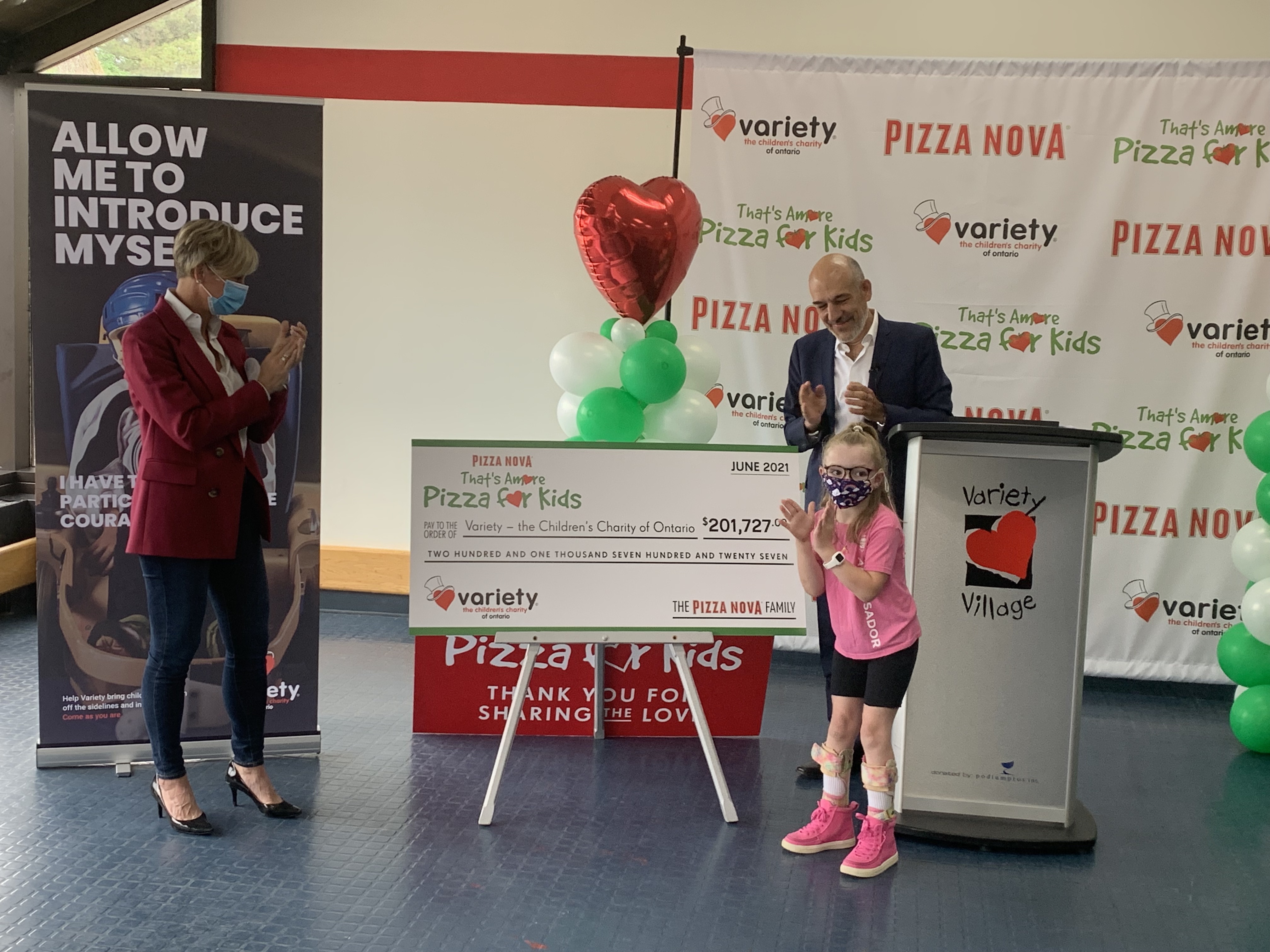 Pizza Nova President Domenic Primucci (right), presents the proceeds from “That’s Amore Pizza for Kids” 2021 to Variety - the Children's Charity of Ontario President and CEO Karen Stintz (left) and Madi Ambos, Variety Ontario Brand Ambassador (front right)