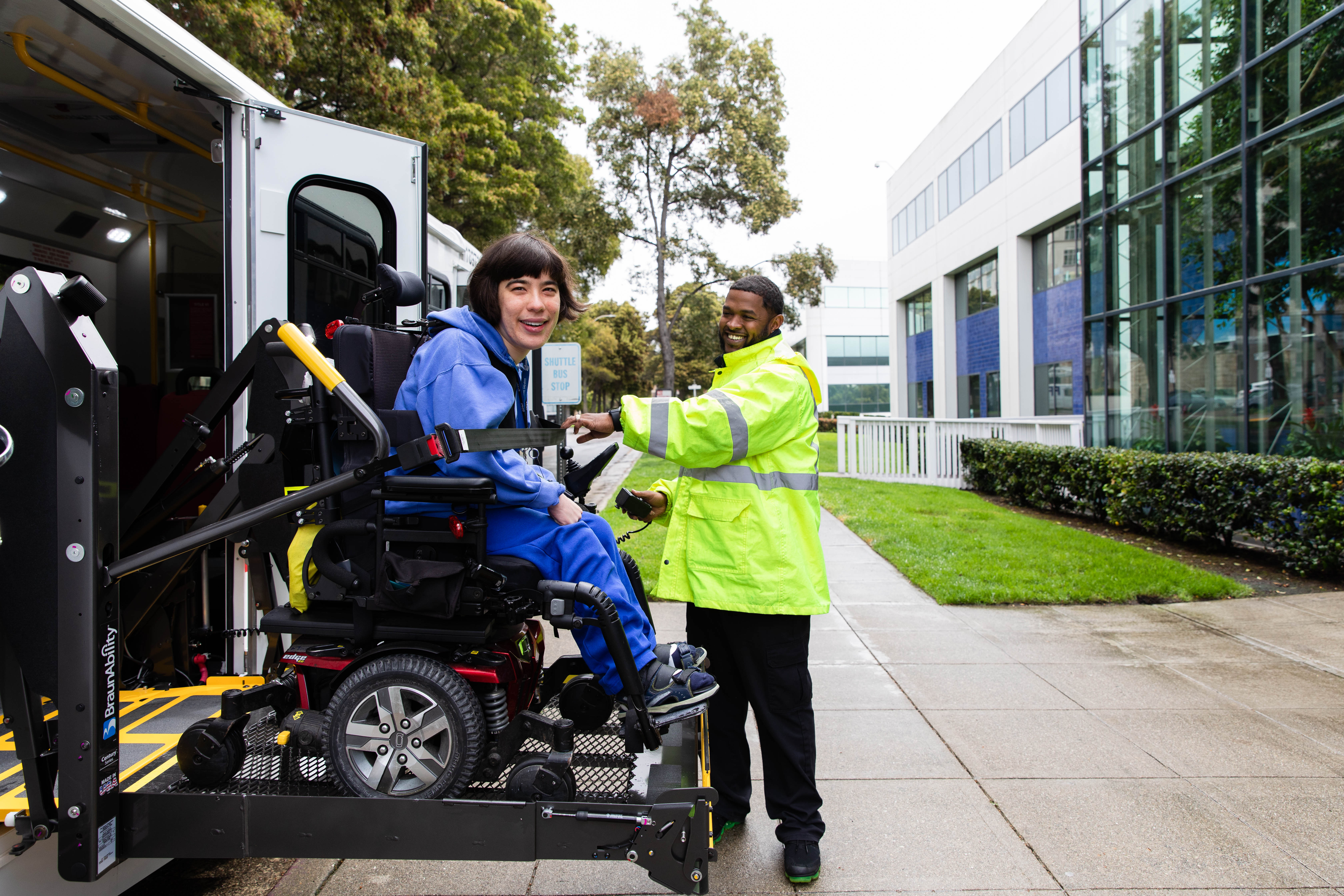 Transdev Employee Assisting Rider into Paratransit Vehicle