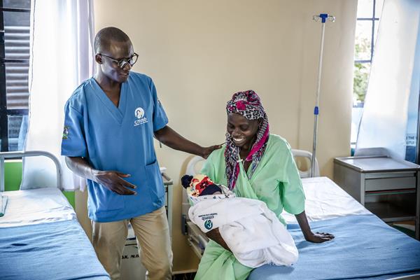 Inside newly-built maternity ward in rural Kenya with doctor and new mom