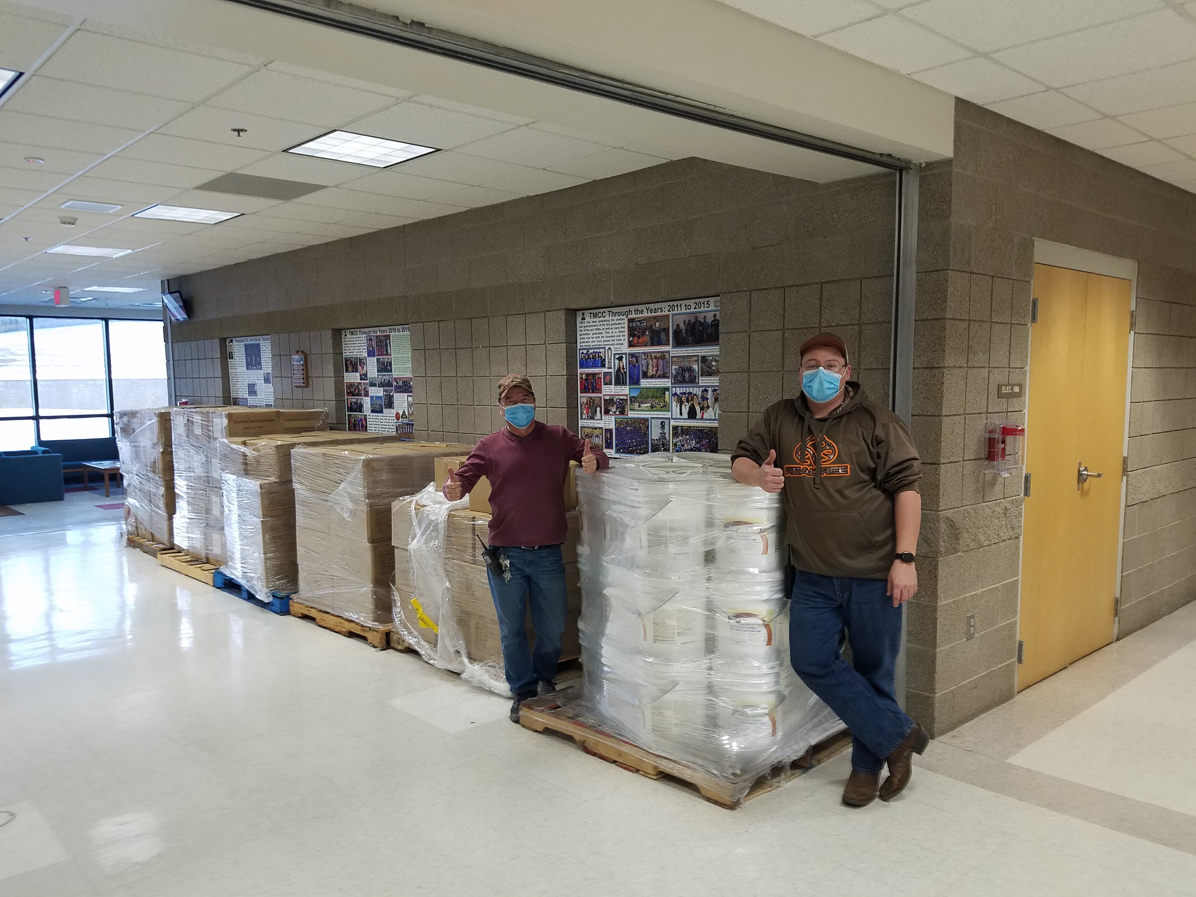 Albert Gourneau (left) and Anthony Desjarlais (right) from Turtle Mountain Community College’s facilities department prepare to distribute sanitizing supplies and safety equipment at the tribal college campus in Belcourt, North Dakota. 