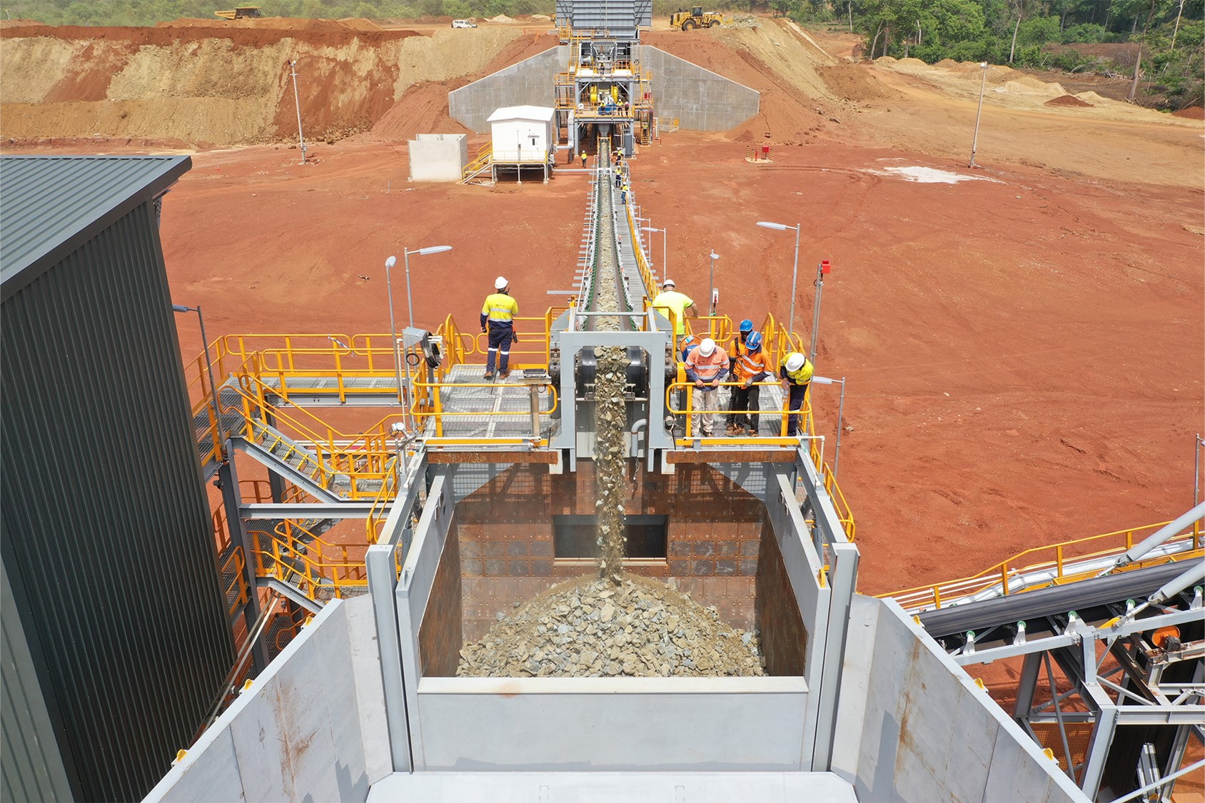 Mineralized material being crushed and conveyed to the stockpile
