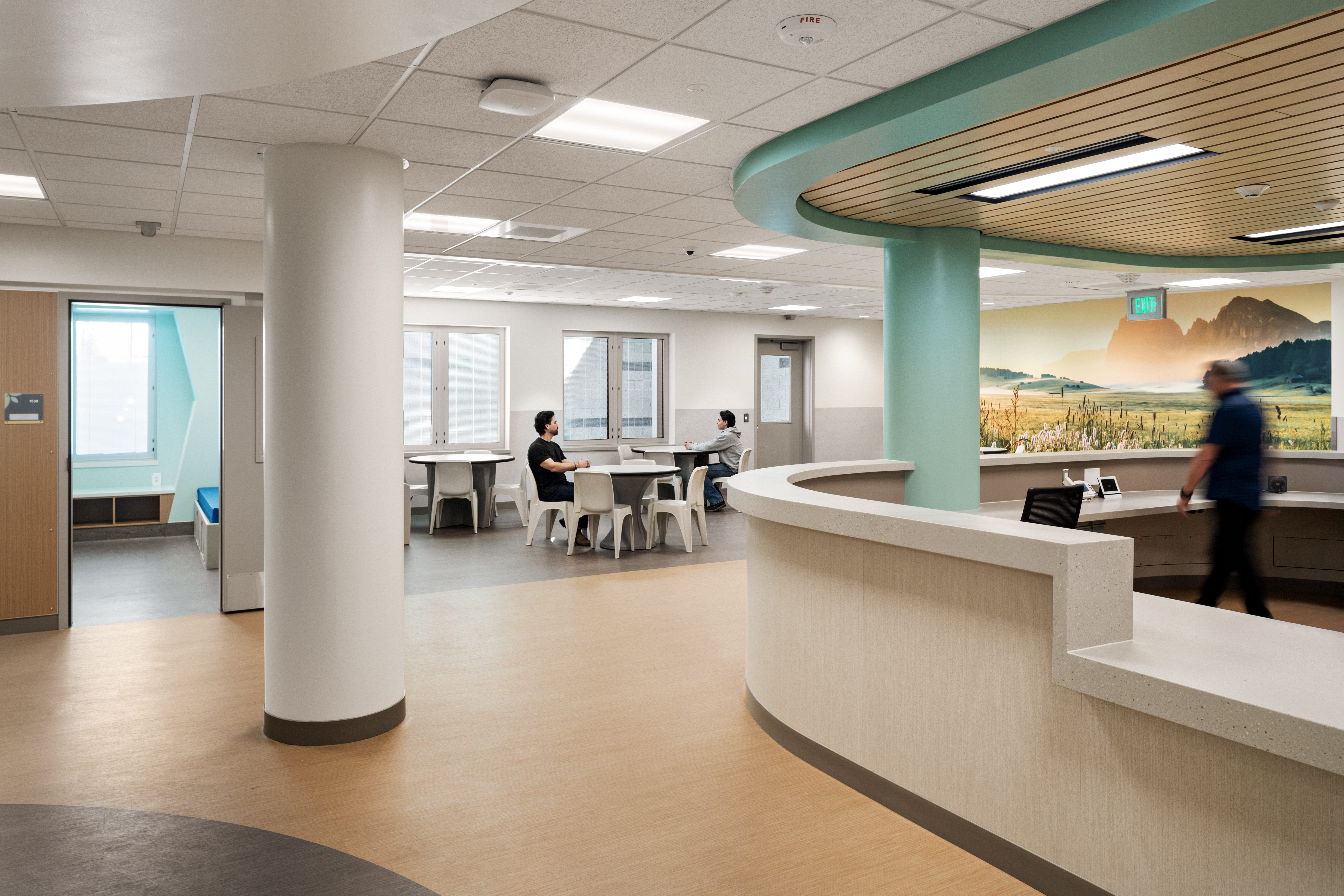 Common area inside the Crisis Stabilization Center at Columbia Valley Center for Recovery, featuring a curved nursing station and dining tables.