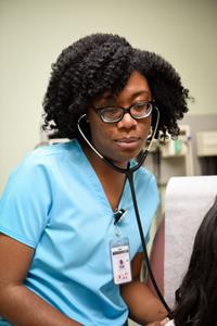 A nursing major at Georgia College & State University learns patient skills.