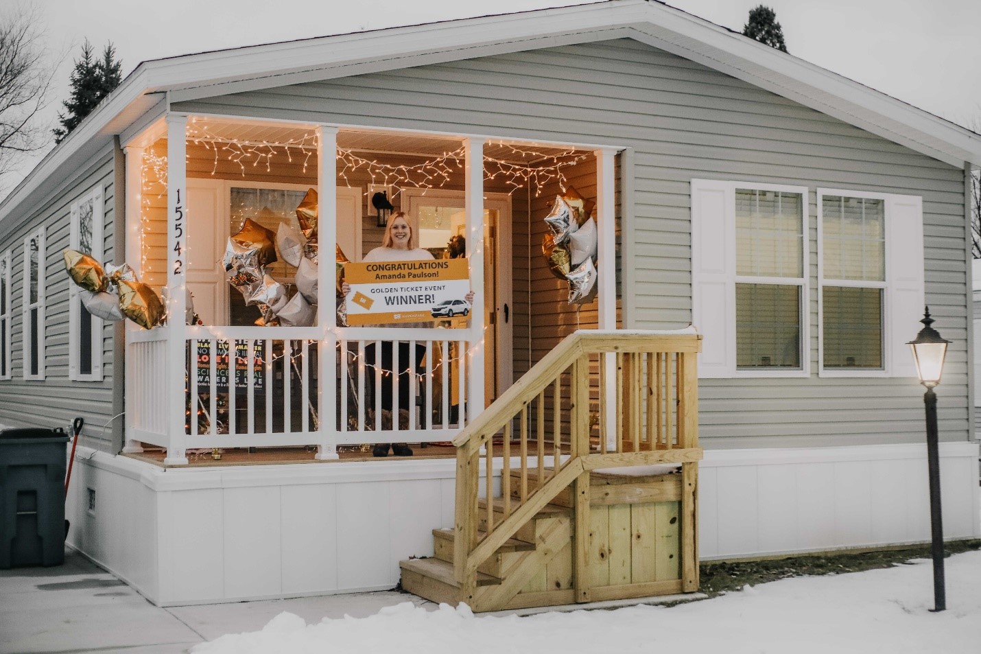 Amanda Paulson standing on the porch of her new home