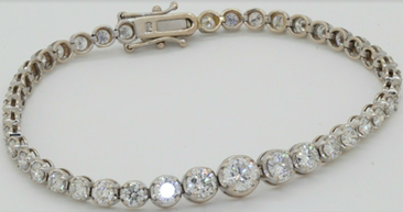 18K WG beautiful 7.54CTW VS graduated diamond tennis bracelet w./ .65CT ctr. Sold for $4,794