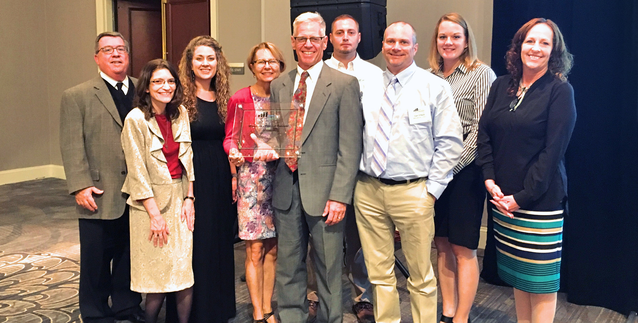 Minuteman Press Hanover franchisees Kitty and Scott Kurz (center) celebrate their Top 50 Fastest Growing Companies of 2019 Award