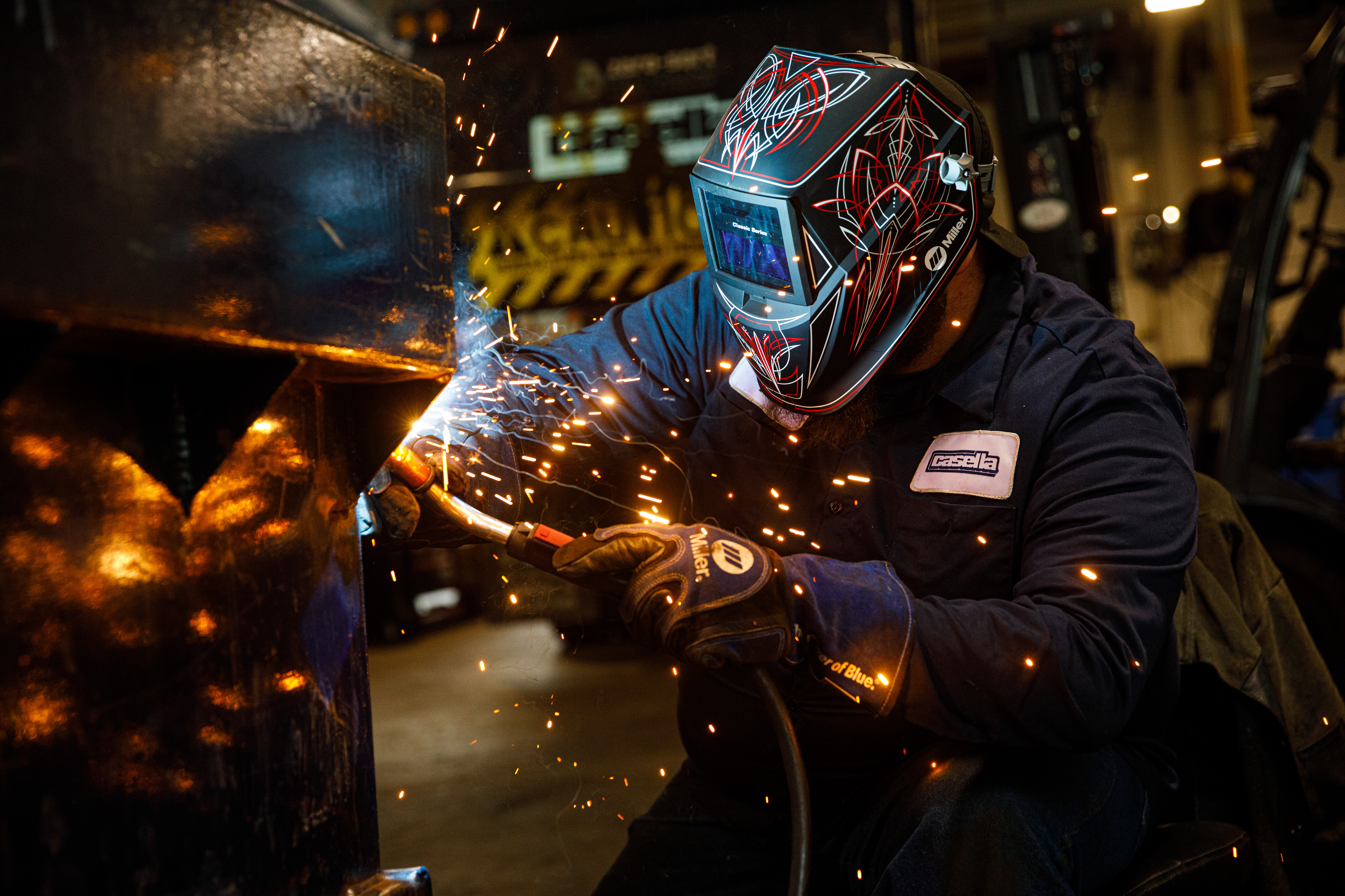 A Casella diesel technician uses a welder to repair a container.