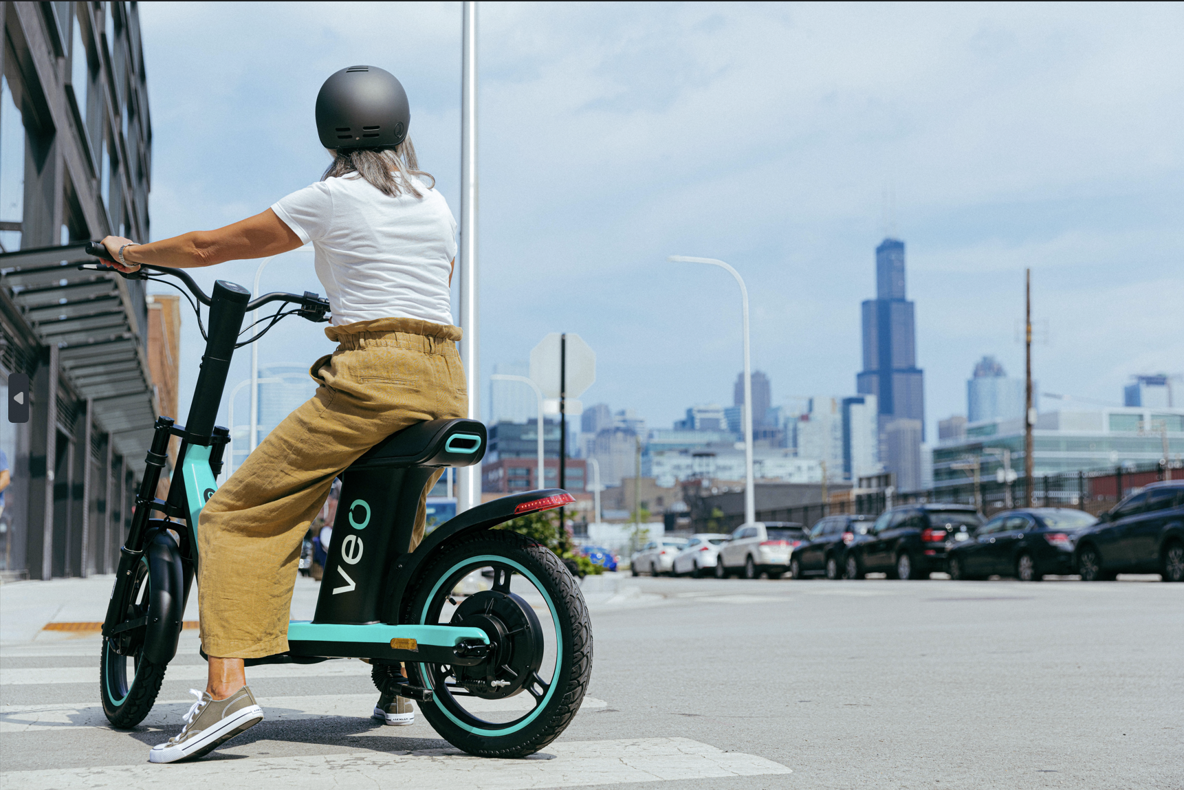 A woman on a seated e-scooter