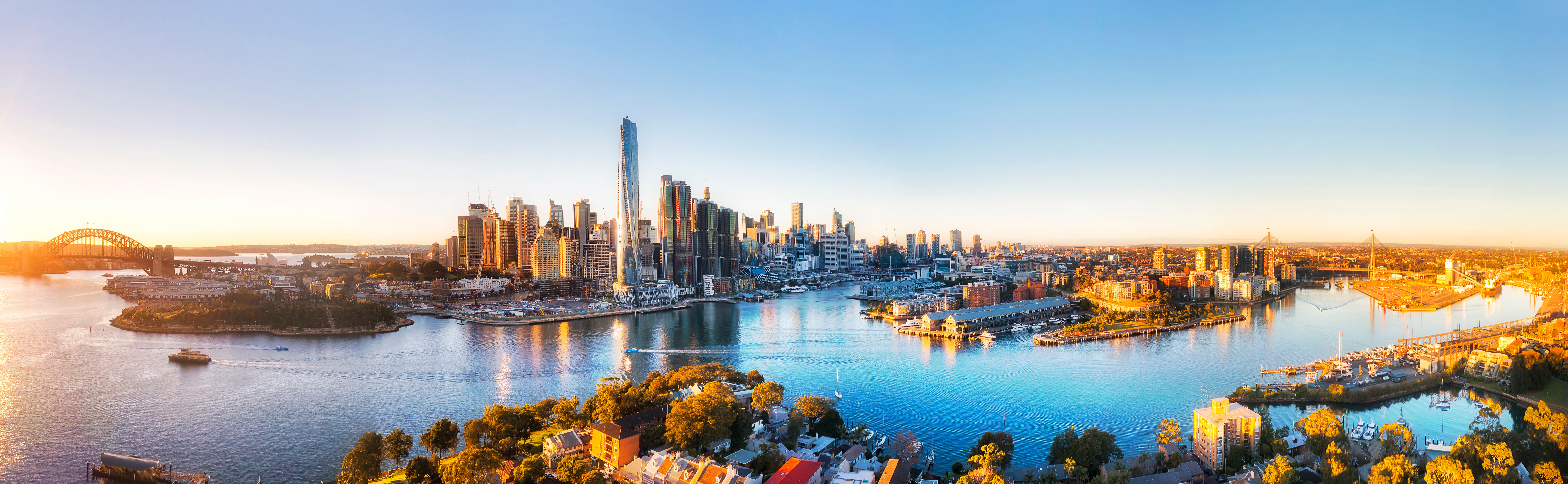 Aerial panorama of Sydney Harbour and the Western Harbour Tunnel project area at sunrise.