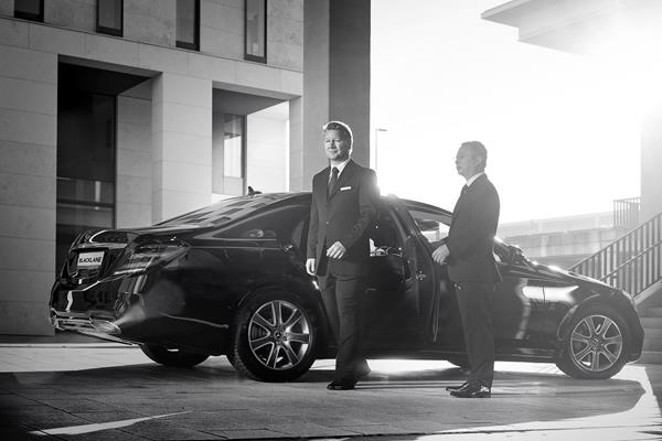 Blacklane -- Chauffeur holding door for guest