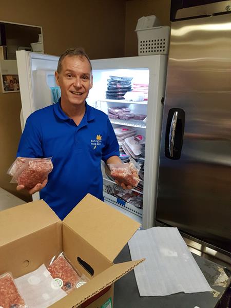 Feed Ontario volunteer refrigerates donated fresh ground Ontario pork.