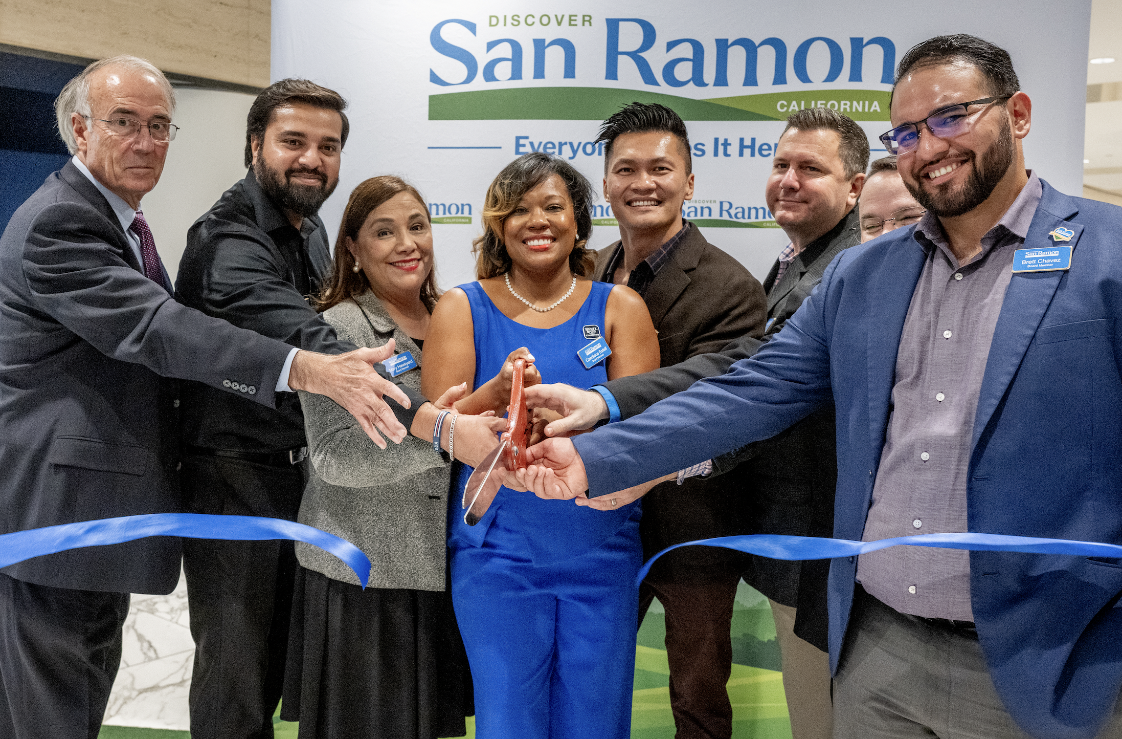 The event included a ribbon-cutting ceremony and heartfelt testimonials from business owners and community residents, highlighting the welcoming atmosphere for kids and families, safety, scenic beauty, and rich local amenities as key reasons why “Everyone Loves It Here.”