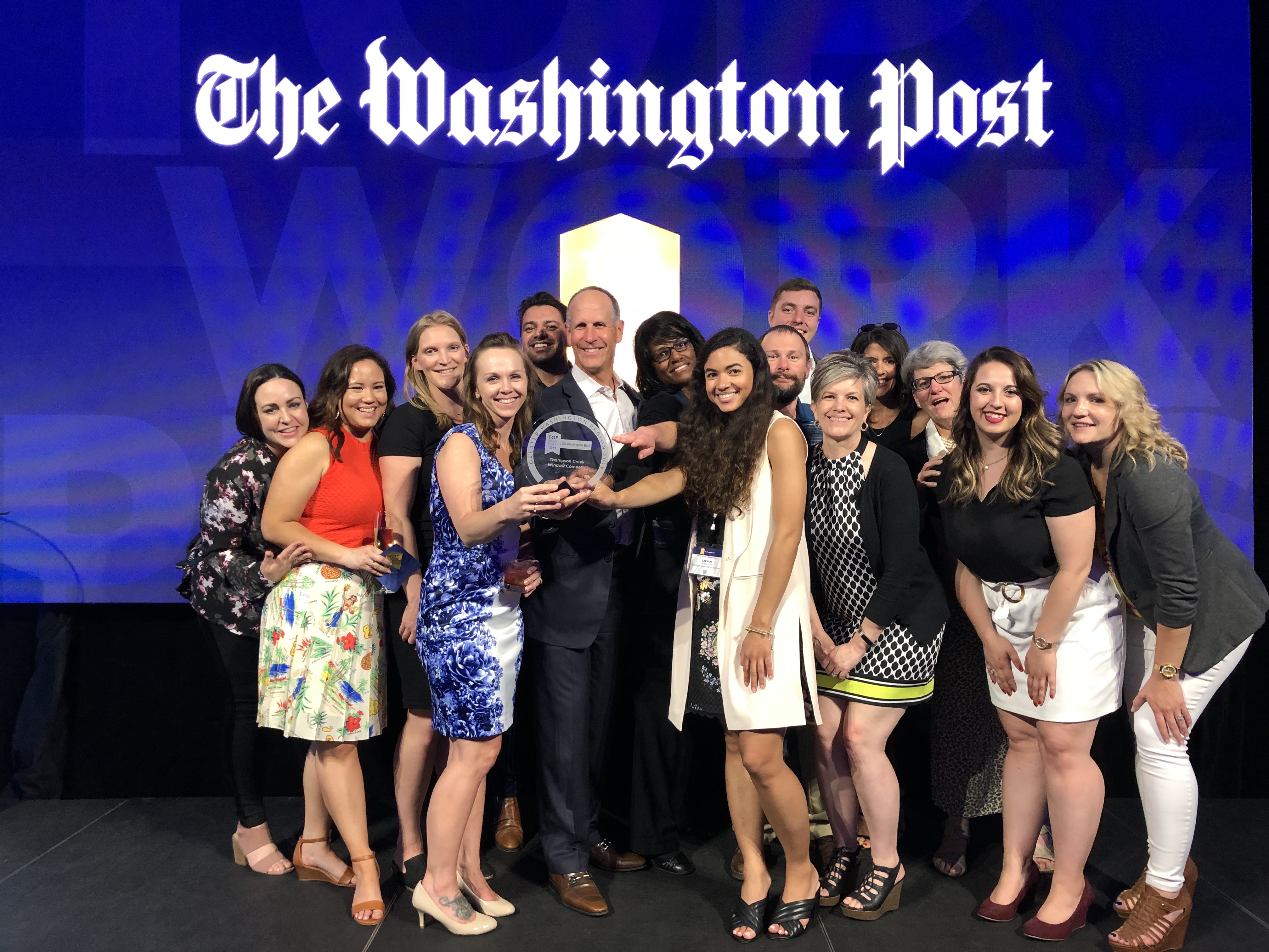 Thompson Creek employees flank CEO and President Rick Wuest in this photo from The Washington Post's 2019 celebration of Top Workplaces. 