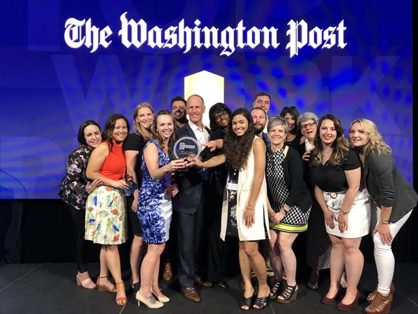 Thompson Creek employees flank CEO and President Rick Wuest in this photo from The Washington Post's 2019 celebration of Top Workplaces. 
