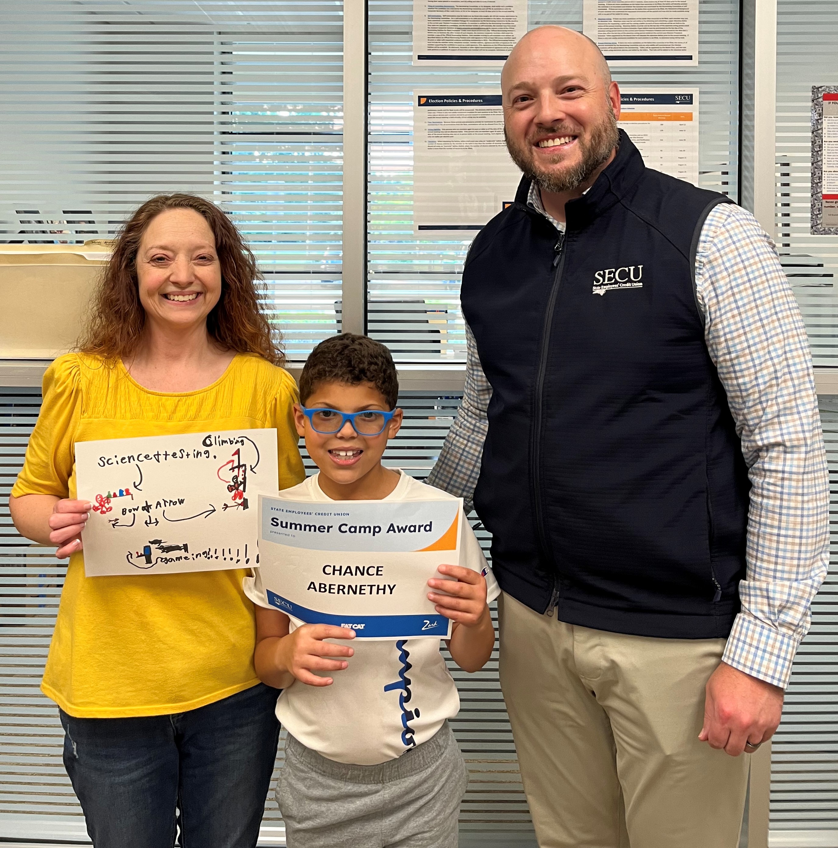 Amanda Abernethy and her son Chance were all smiles as he received his Summer Camp Award from SECU Vice President Jared Ramsey at the Hickory-Mountain View Branch.