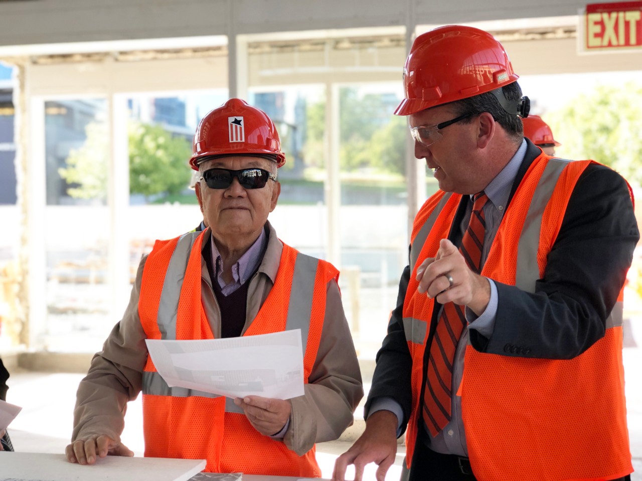 Kwang G. Tan, left, touring the construction site of the National Veterans Resource Center at the Daniel and Gayle D’Aniello Building.