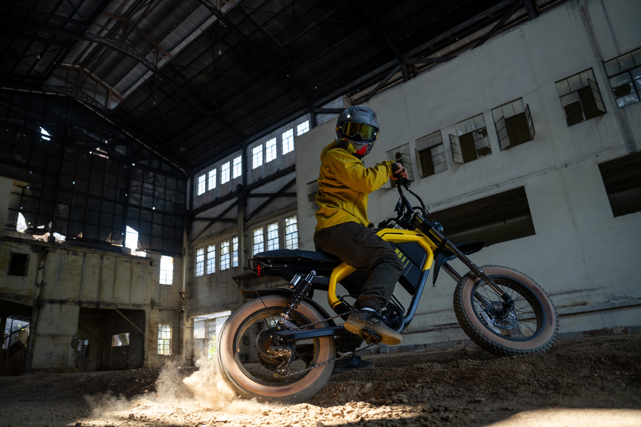 Rider maneuvering the Luckeep M5 Max dual-battery electric moped eBike on loose dirt inside an industrial building