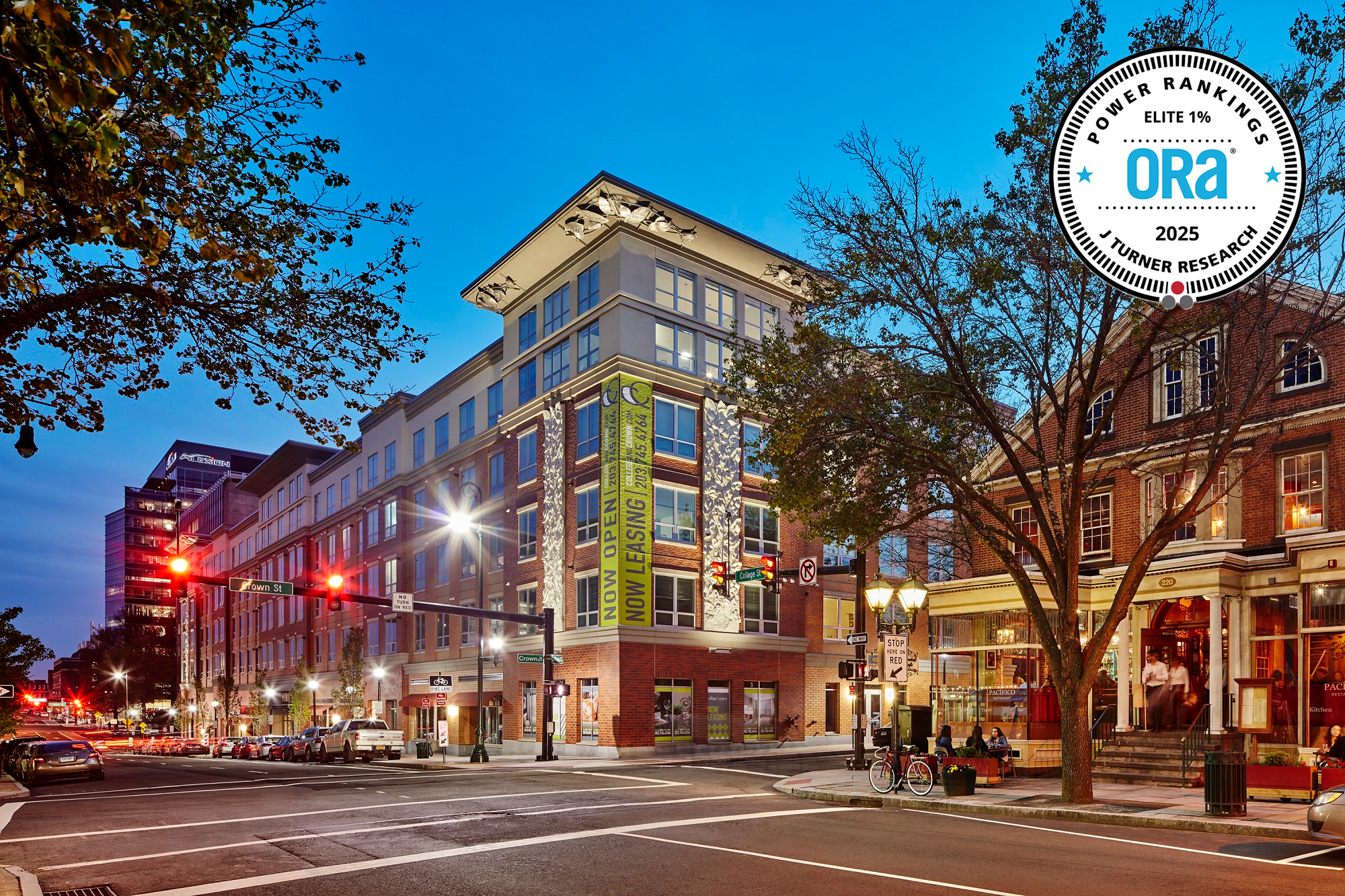Exterior dusk view of The Haven on College, a mixed-use residential property on a street corner in New Haven, Connecticut, with an Elite 1% ORA badge