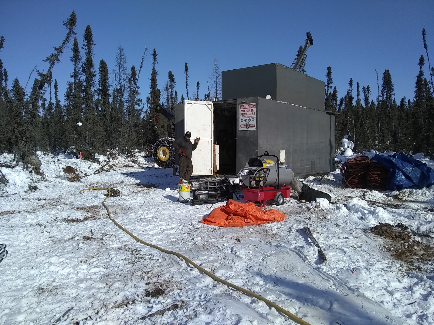 A photograph of the diamond drill shack at the KLS Project with snow.