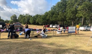 Members of Canaan Baptist Church participate in a clothing drive on property owned by the church.