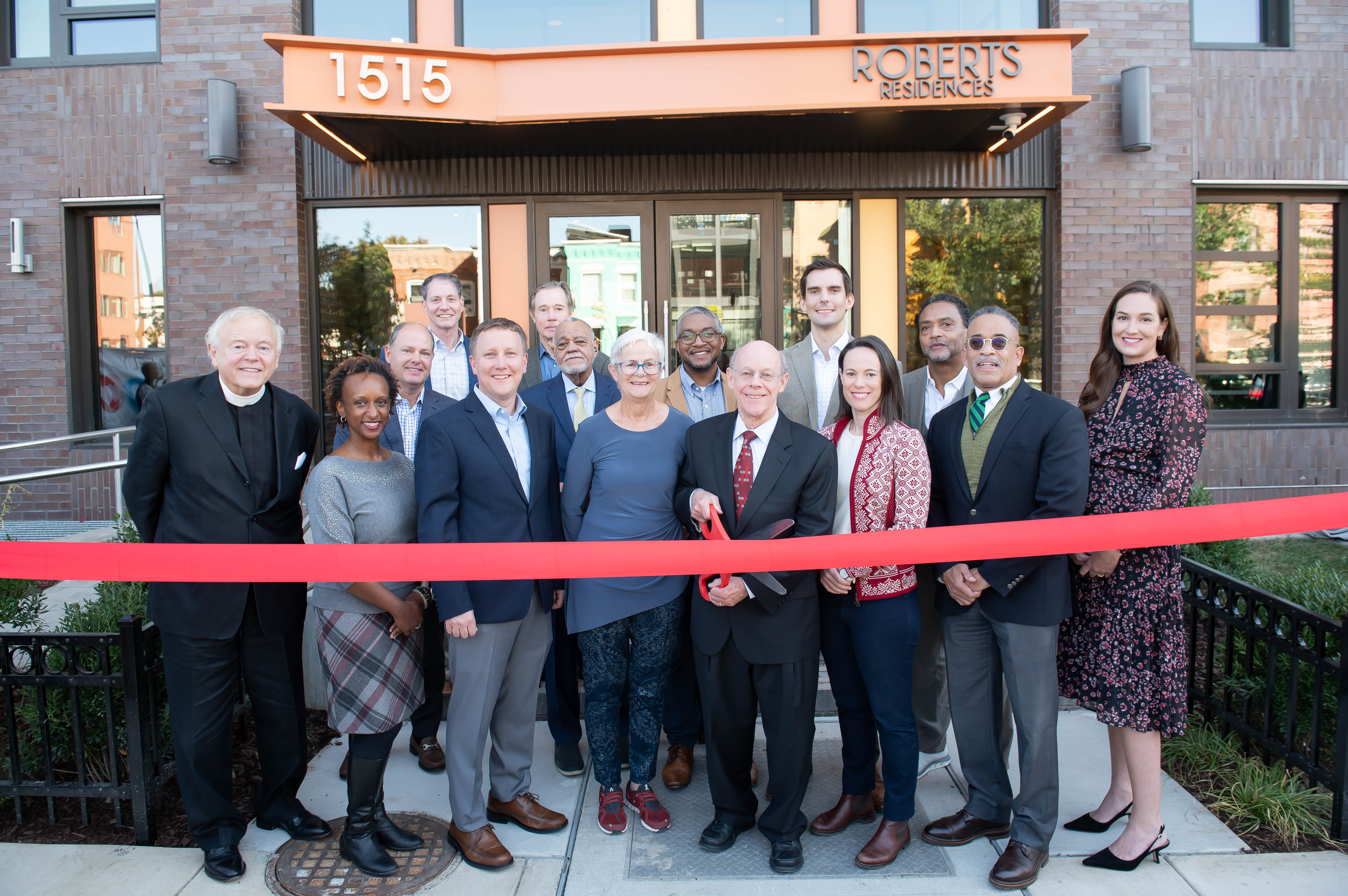 Bob Roberts, President of Roberts Oxygen Company, Inc. and longstanding donor of SOME, joined by leaders of SOME and partners from the Department of Housing and Community Development, DC Housing Finance Agency, JP Morgan Chase, Lument, and Enterprise, unveil the Roberts Residences at 1515 North Capitol Street NE with a ceremonial ribbon cutting. Spanning 92,000 square feet and rising 15 stories, the affordable housing development boasts 139 efficiencies and junior 1-bedroom apartments, complemented by amenities such as a computer lab, library, classrooms, a fitness room, and laundry facilities on each floor on Thursday, Oct. 12, 2023 in Washington. (Joy Asico/AP Images for SOME)