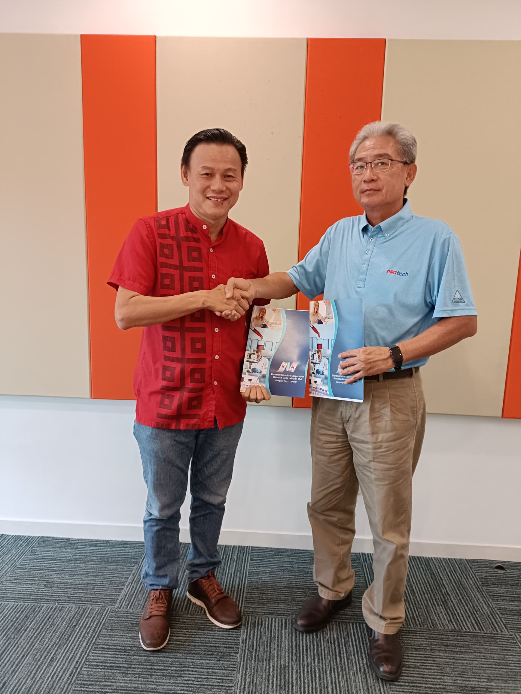 Mr. Lai representing BioNexus Gene Lab Corp. (BGLC) and Mr. Wong representing Protech Builders Sdn. Bhd. (Protech) during the handover of agreements