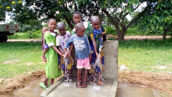 Children test out the new well