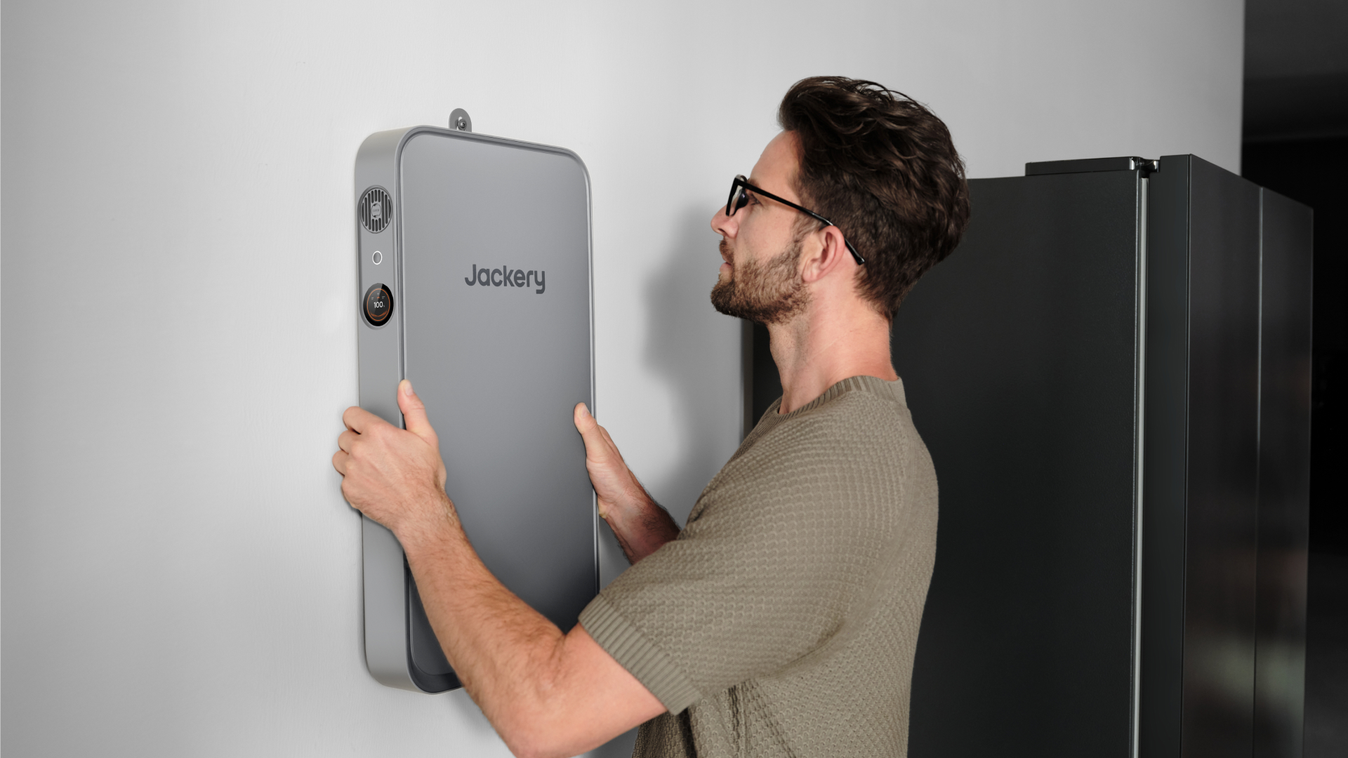 Jackery FridgeGuard mounted beside refrigerator 