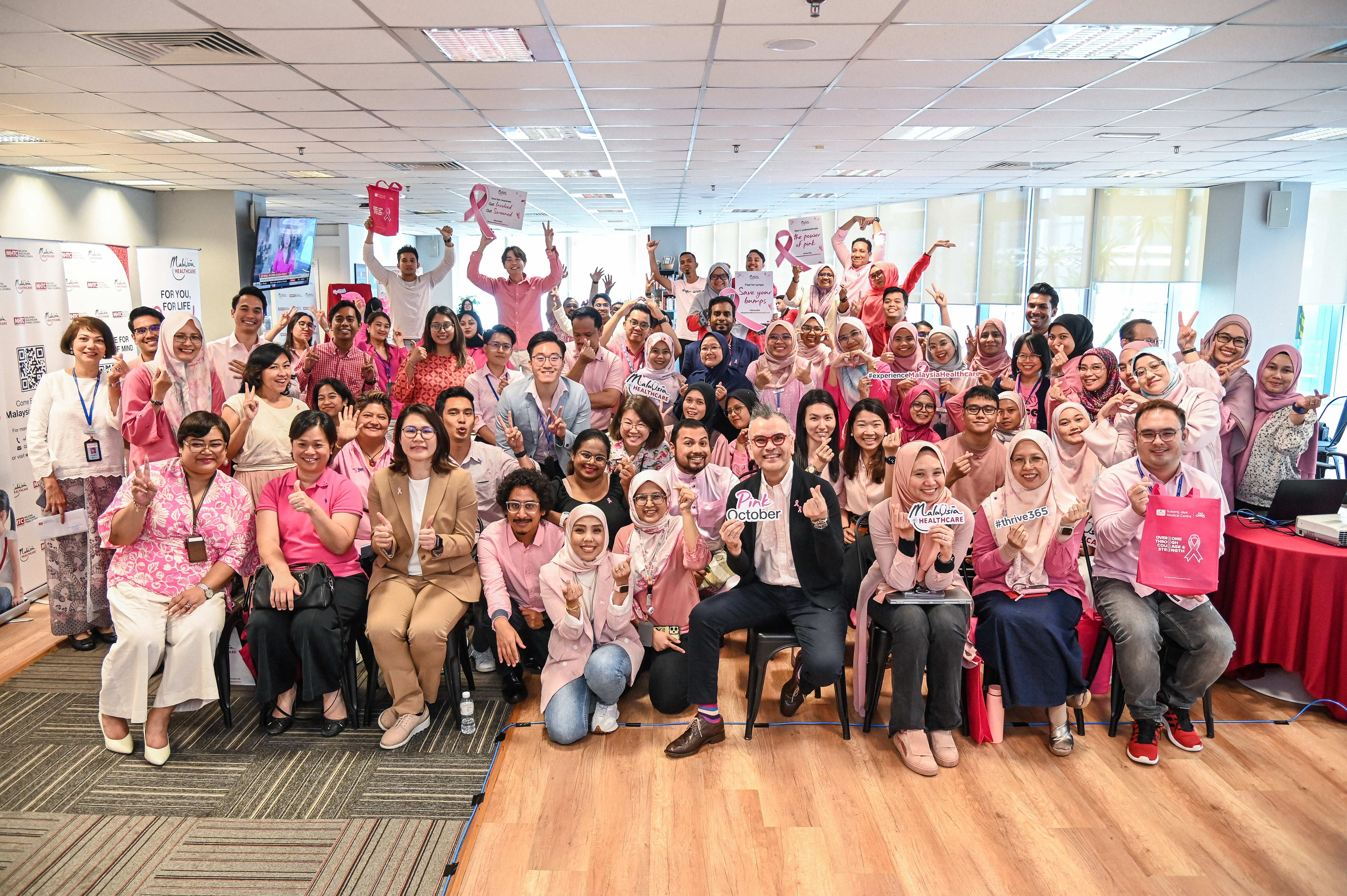 Participants of MHTC Breast Cancer Awareness Day, themed "Thrive 365," gathered for a group photo to express their support for the Breast Cancer Awareness Programme.