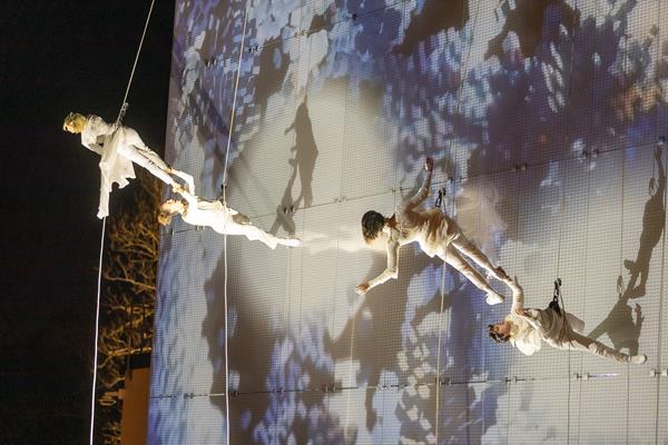 The opening night at The Momentary museum was celebrated with an enigmatic dance on top of the Bendheim projectable glass facade. Photo courtesy of BANDALOOP. 