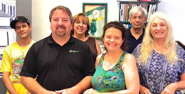 Bob and Teresa Stone (front and center) are second-generation owners of the Minuteman Press design, marketing, and printing franchise in Sarasota, FL.