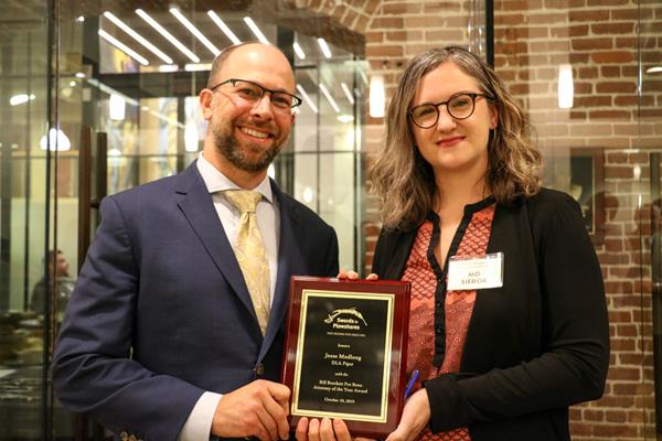 Jesse Medlong, DLA Piper, accepting the 2019 Bill Brockett Pro Bono Attorney of the Year award from Swords to Plowshares Legal Director, Maureen "Mo" Siedor.