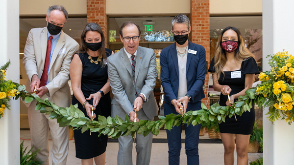 (L_R) Trinity Trustee Herb Stumberg, Jackie Moczygemba of the Ewing Halsell Foundation, Trinity President Danny Anderson, Vice President of Academic Affairs Megan Mustain, and student Maria Arteaga cut the ribbon officially reopening the historic Halsell Center. Photo by Ryan Sedillo.