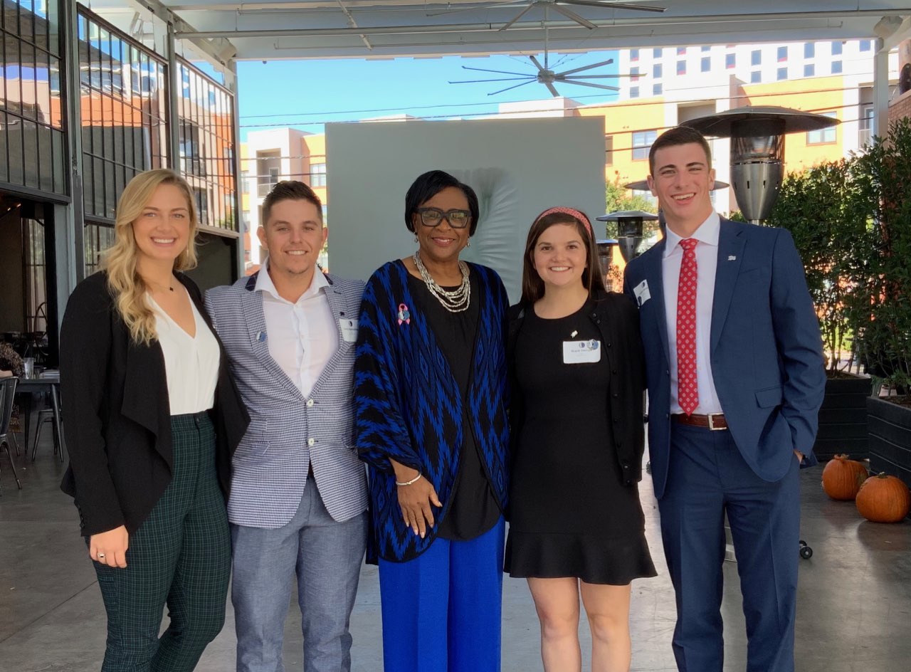 High Point University students (left to right) Sylvanna Schiefele, Chris Apecechea, Grace George and Parker Murphy spent the day shadowing Dallas Mavericks CEO Cynt Marshall (center). 