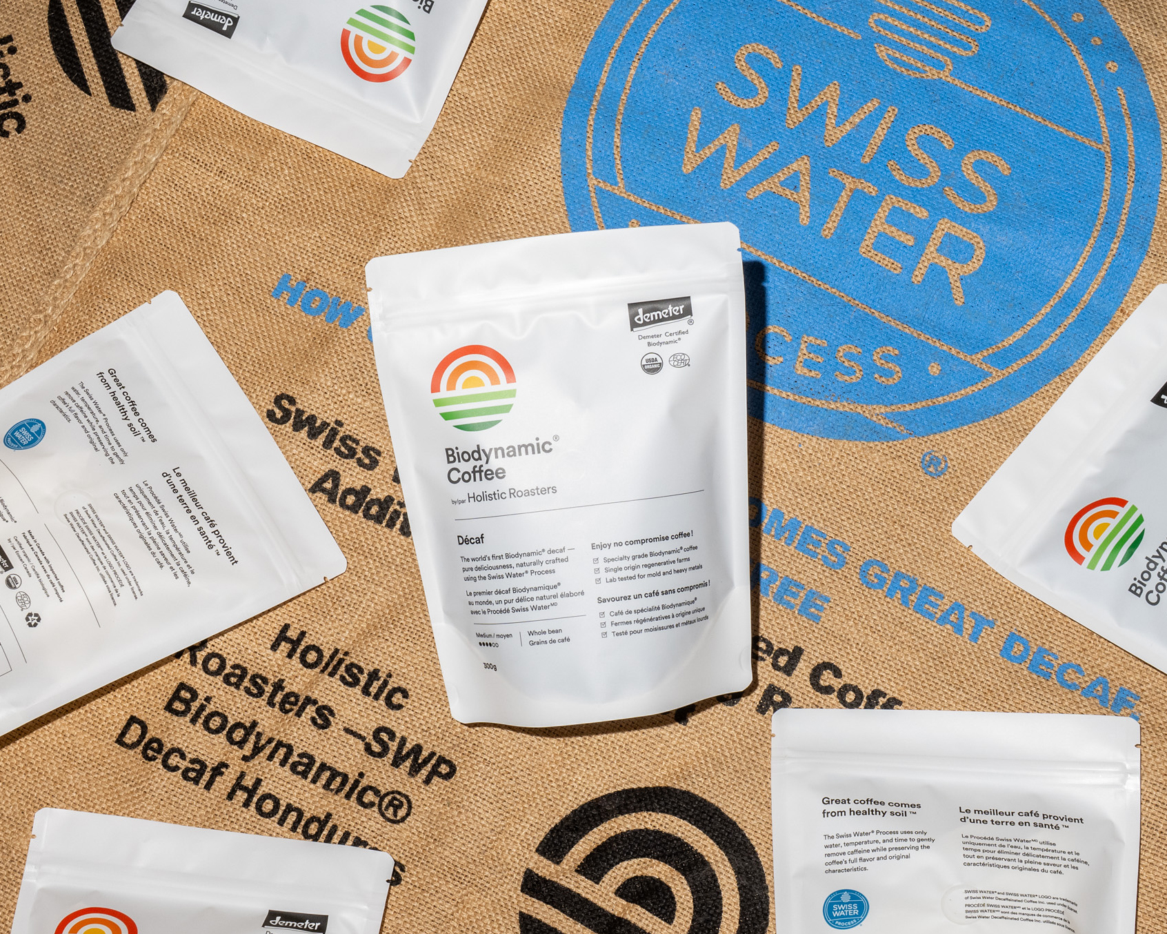 Biodynamic Décaf bag of decaf coffee on a Swiss Water® Process green coffee bag, with large blue Swiss Water® Process logo and Holistic Roasters logo