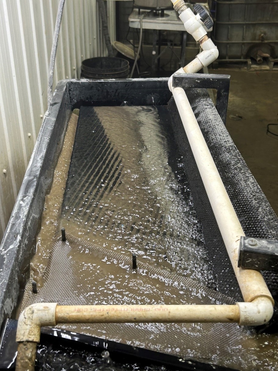 Shaking table. Notice the sharp cut between the pyrite concentrate and the middlings